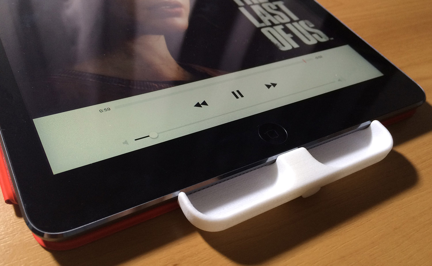 The 3D printed evaluation model of the iPad SpeakerSlide, attached to an iPad Air by the SpeakerSlide's Lightning port plug.