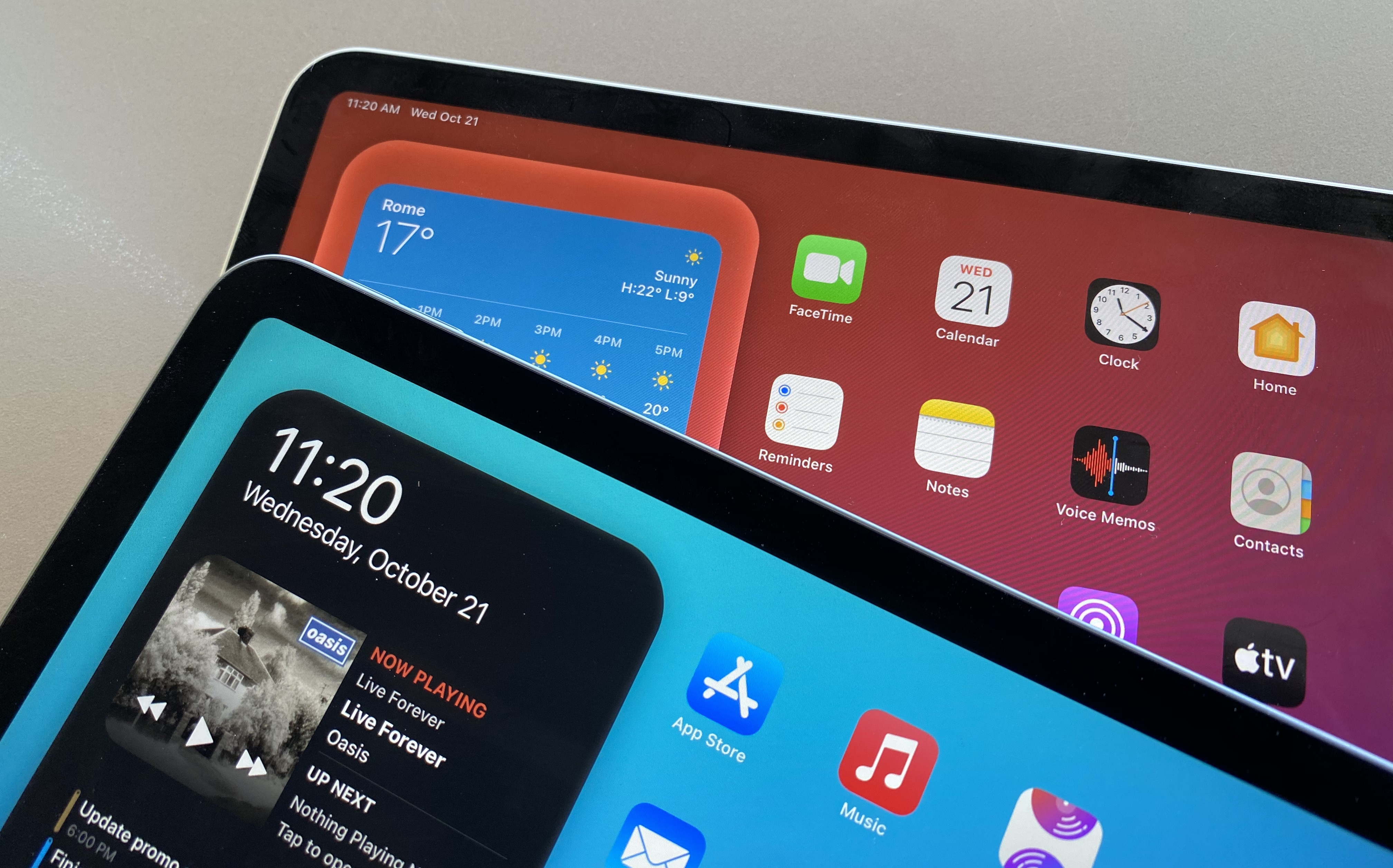 The iPad Air (blue Home Screen) has slightly thicker bezels.
