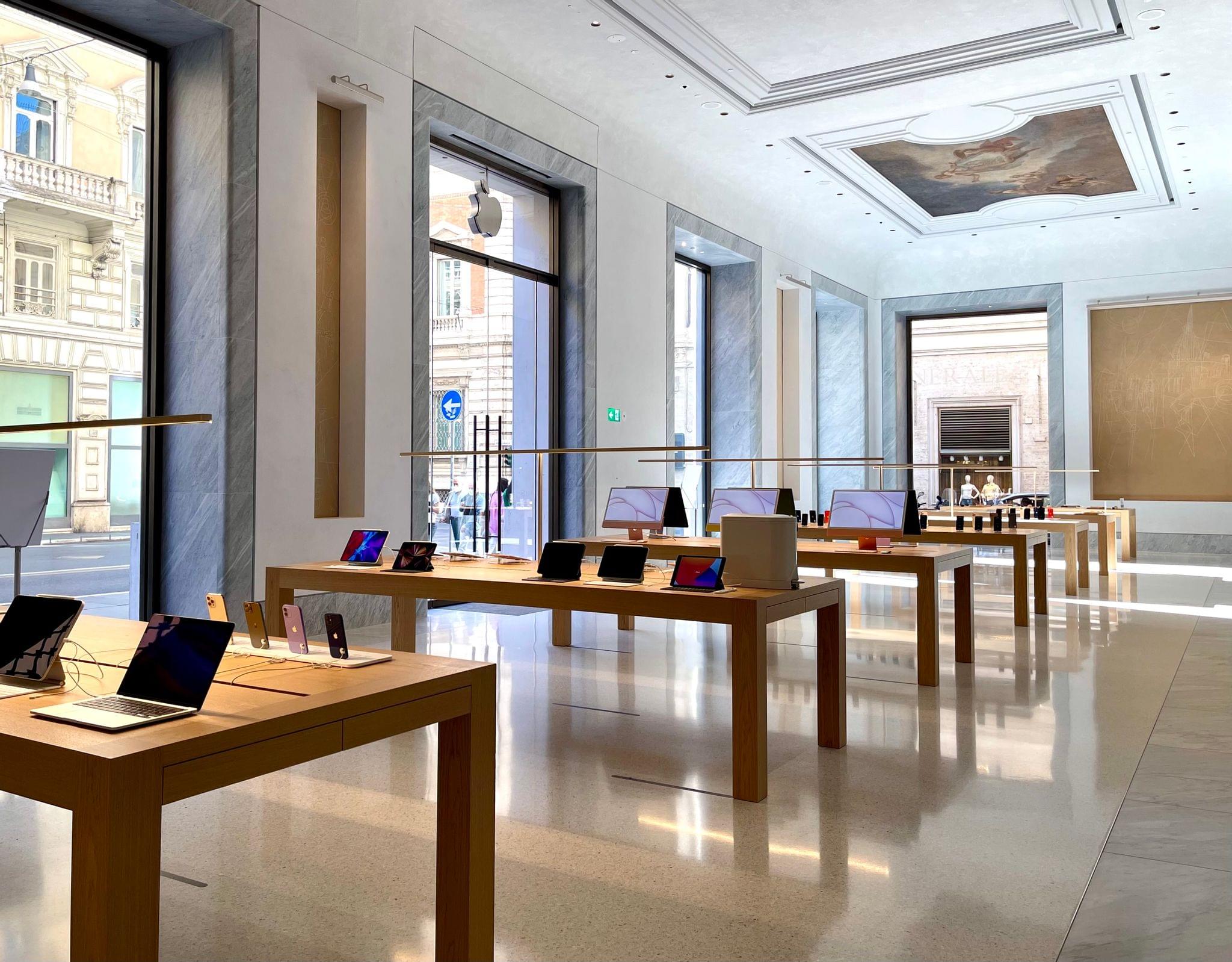 Apple devices, restored ceiling paintings, and the large entrance facing Via del Corso.