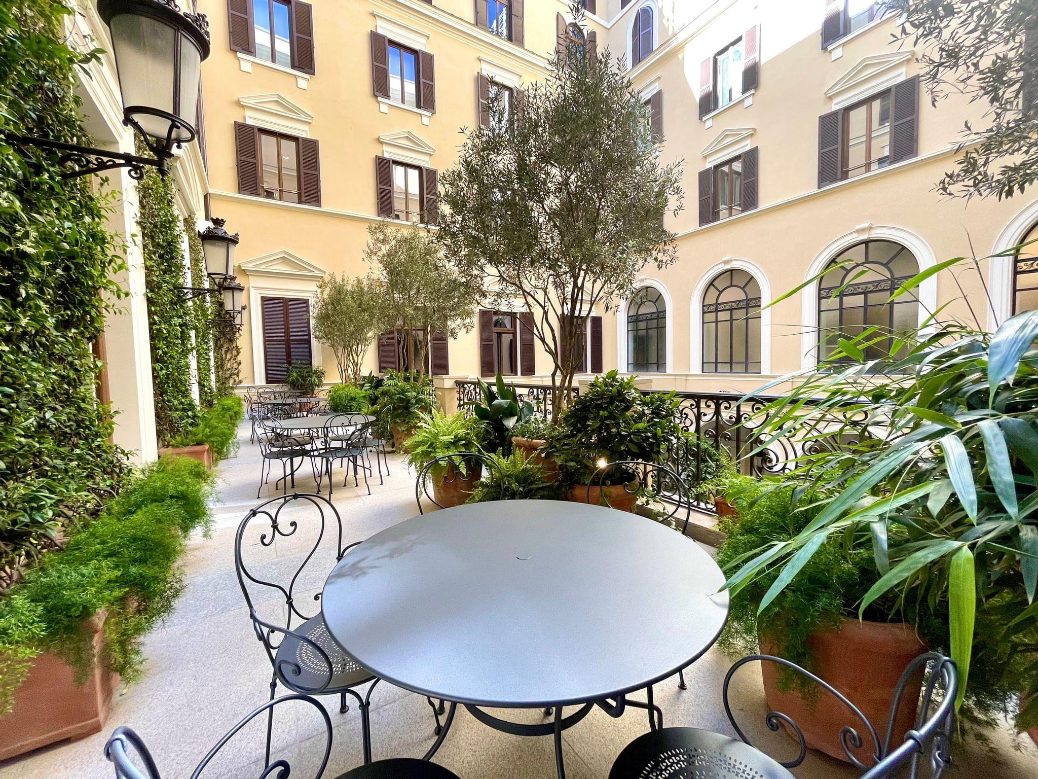 The terrace overlooks the courtyard and features jasmine vines and olive trees inspired by Roman roof terraces.