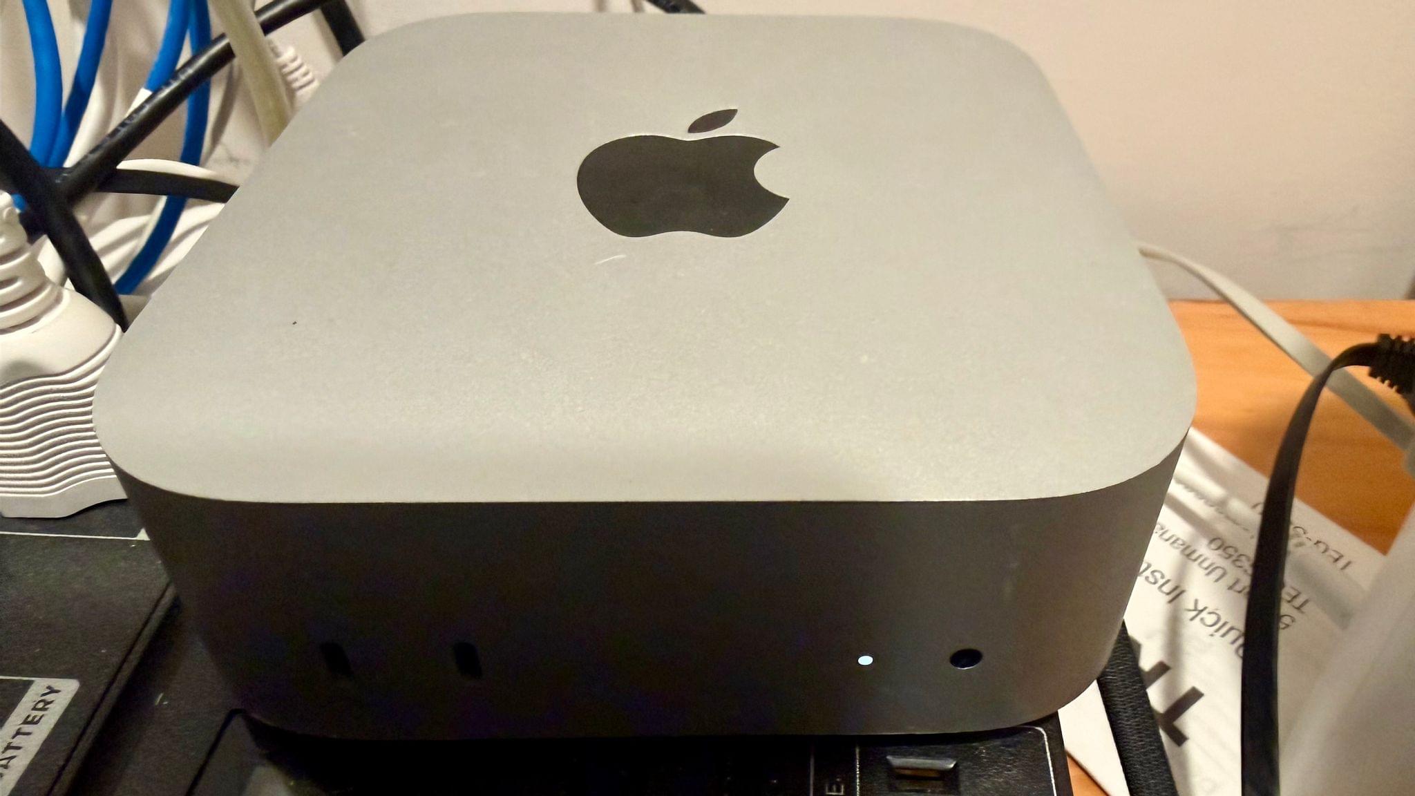 The M4 Pro Mac mini leads a quiet life on top of a backup power supply in a closet.