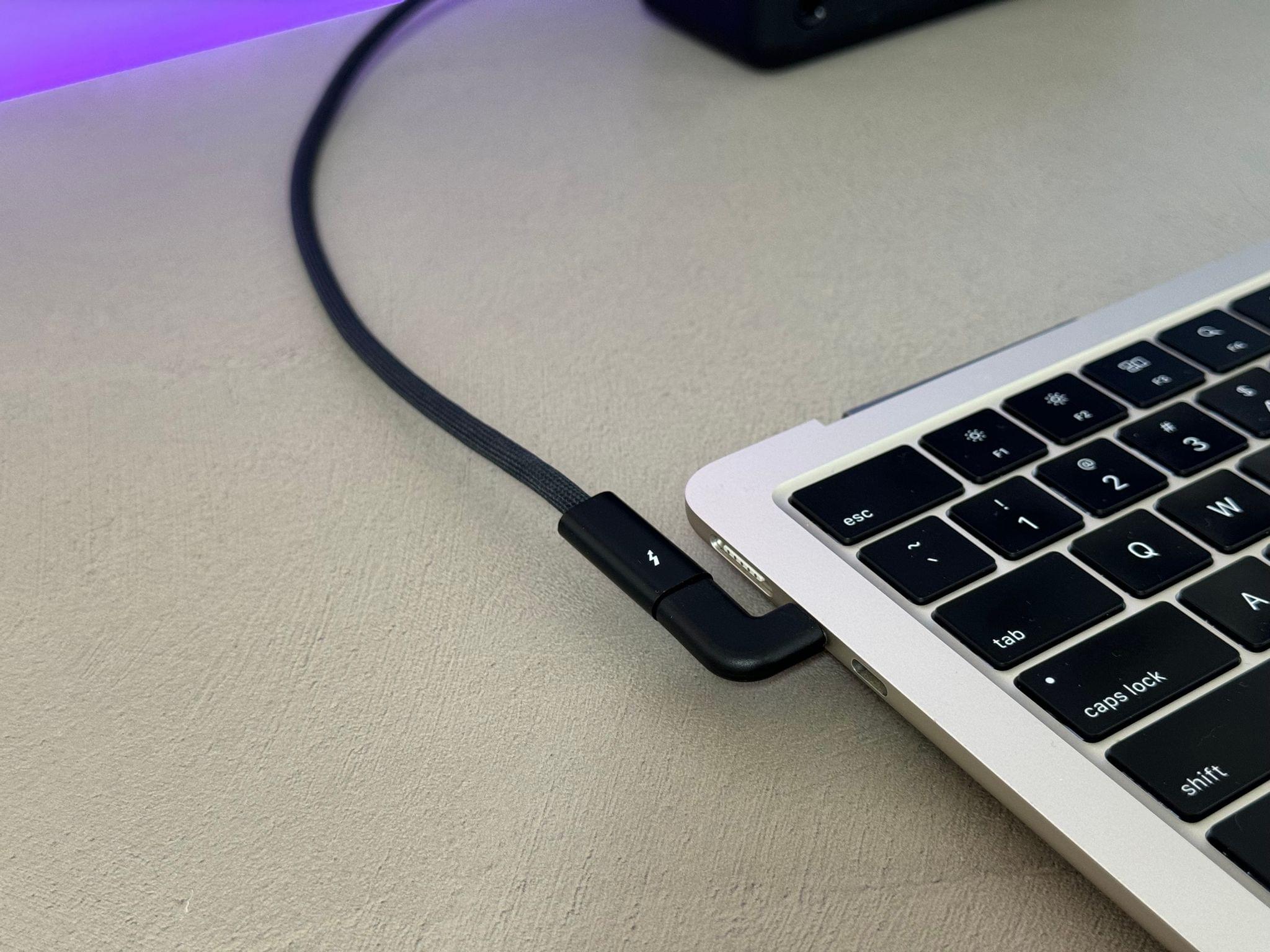 The angled connector lets the Thunderbolt cable remain straight.