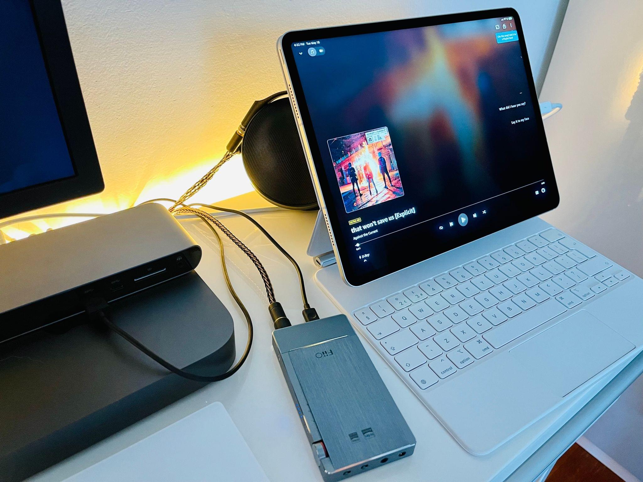 Headphones are plugged with a balanced cable into my FiiO DAC, which is plugged into the Thunderbolt dock, which is connected to the iPad Pro and UltraFine 4K display. I love this setup.
